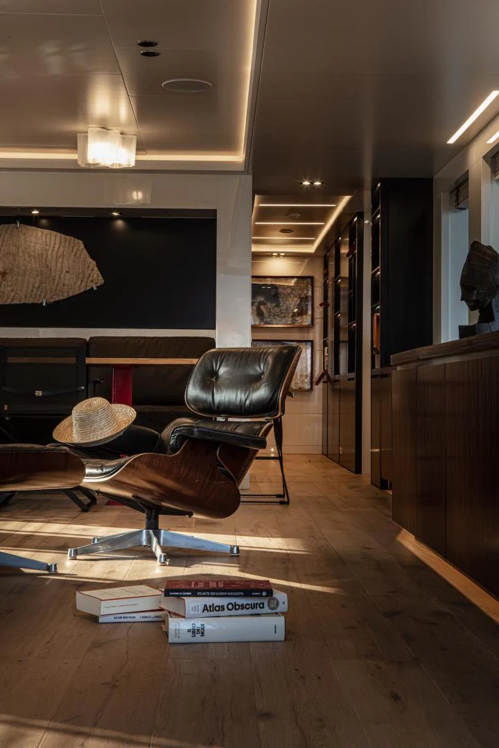 a room with a chair and a piano aboard ATOM Yacht for Sale