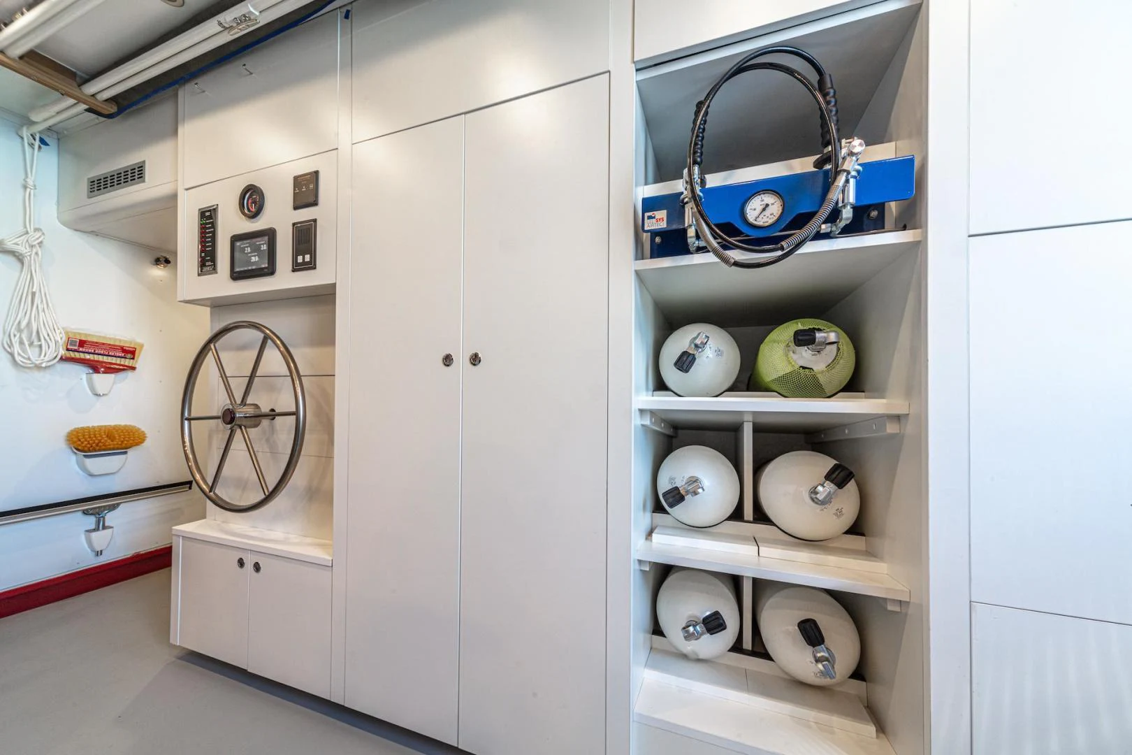 a white cabinet with a few items on it aboard ATOM Yacht for Sale