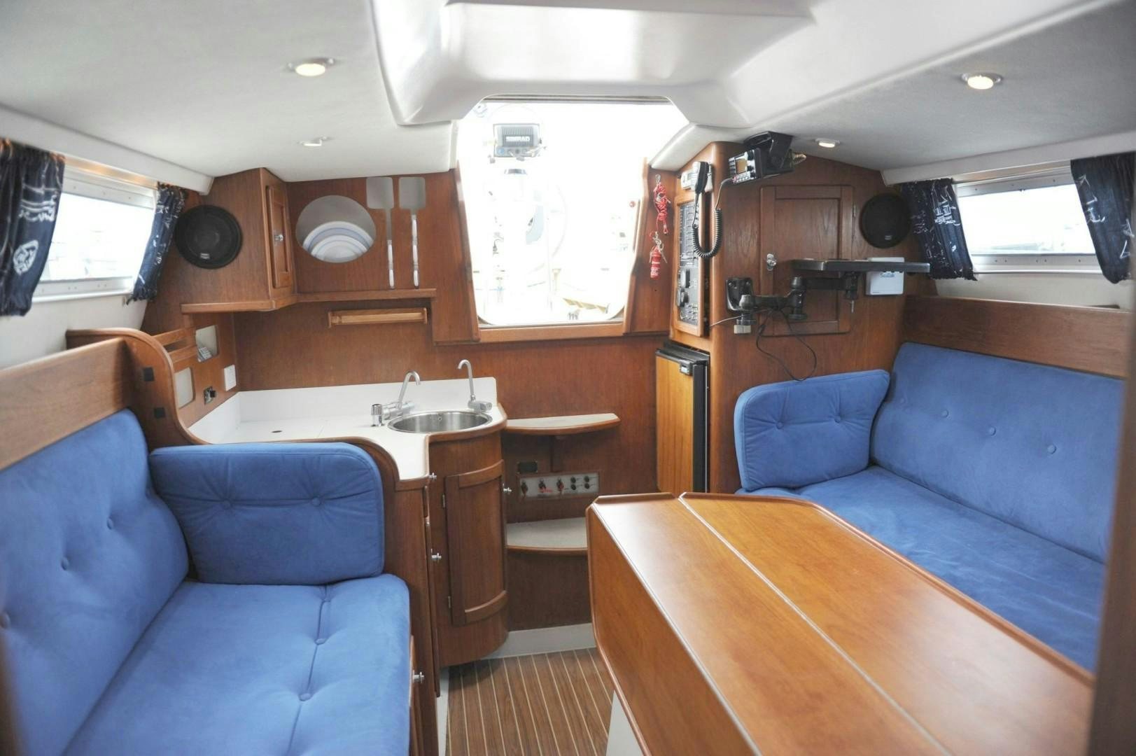 a room with a couch and a table aboard VICTORNOMI Yacht for Sale