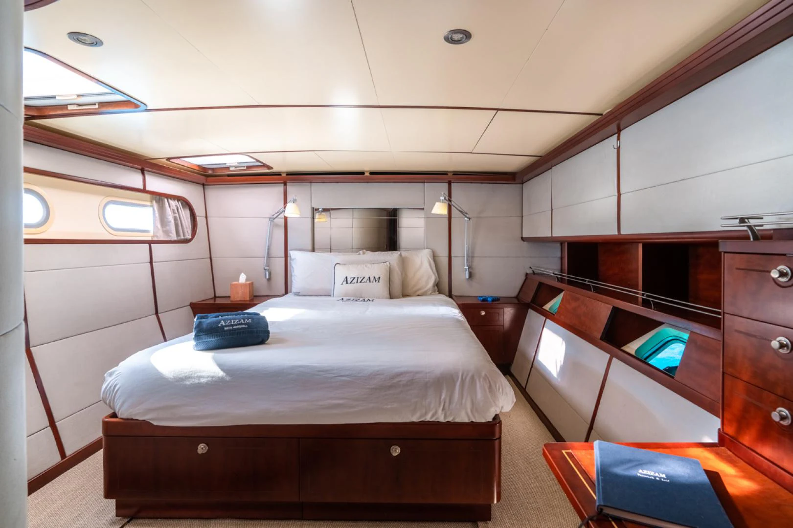 a room with a bed and a desk aboard AZIZAM Yacht for Sale