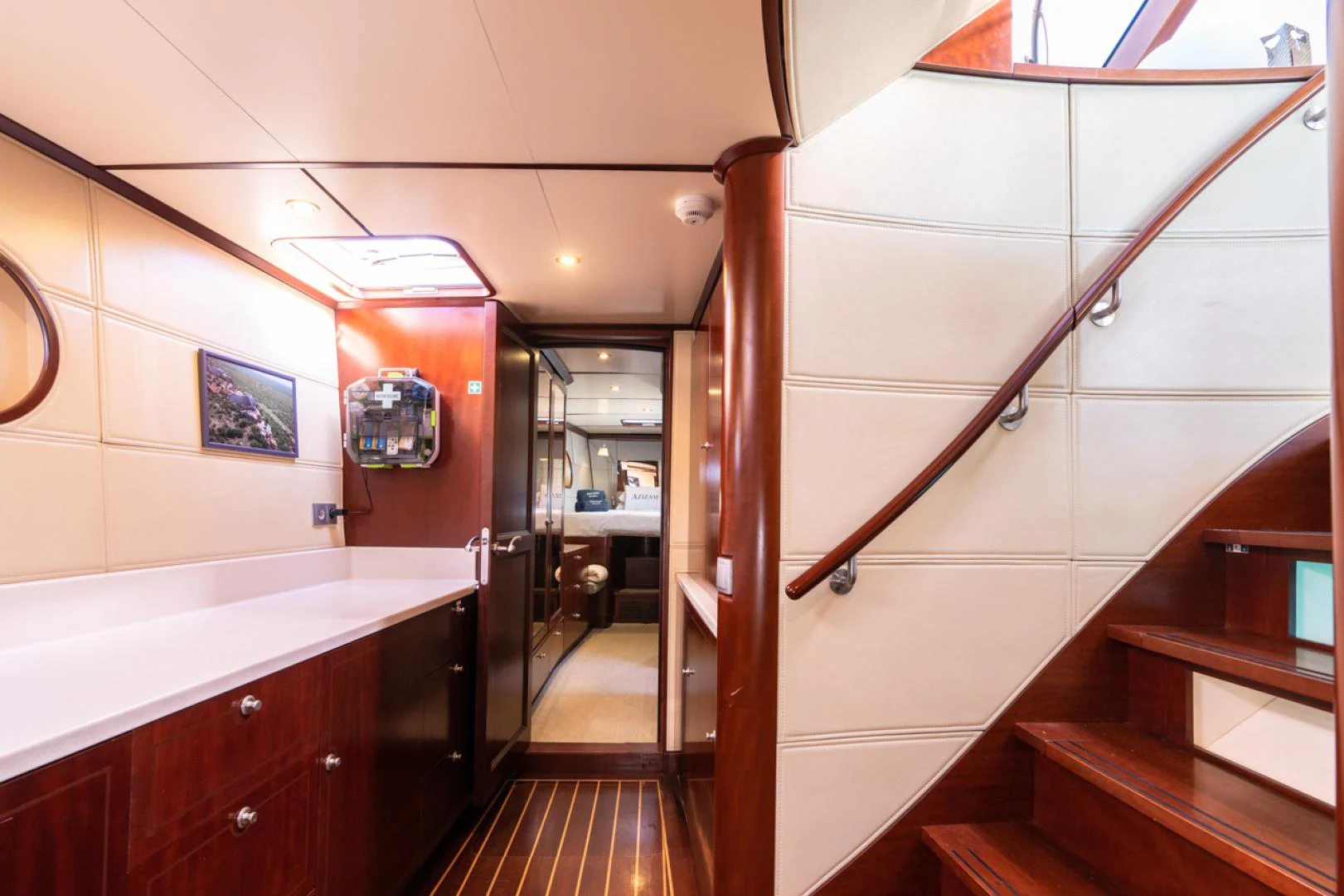 a room with a staircase and a red wall aboard AZIZAM Yacht for Sale