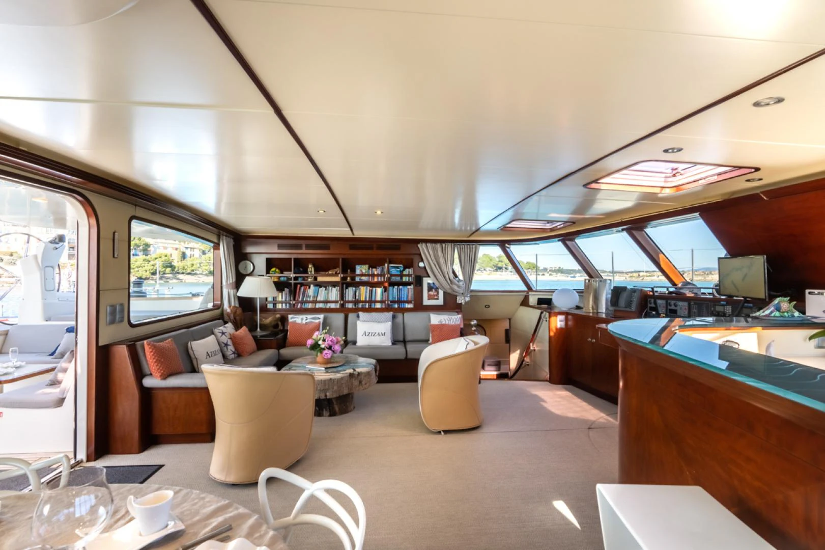 a room with a table chairs and a window aboard AZIZAM Yacht for Sale