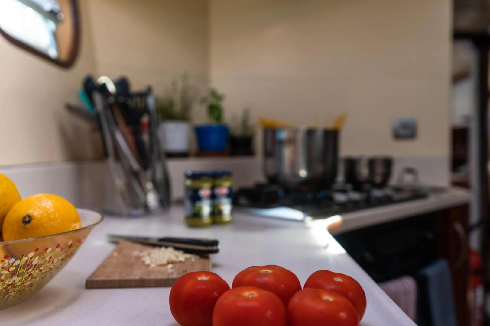 a kitchen counter with tomatoes and other kitchen items on it aboard AZIZAM Yacht for Sale