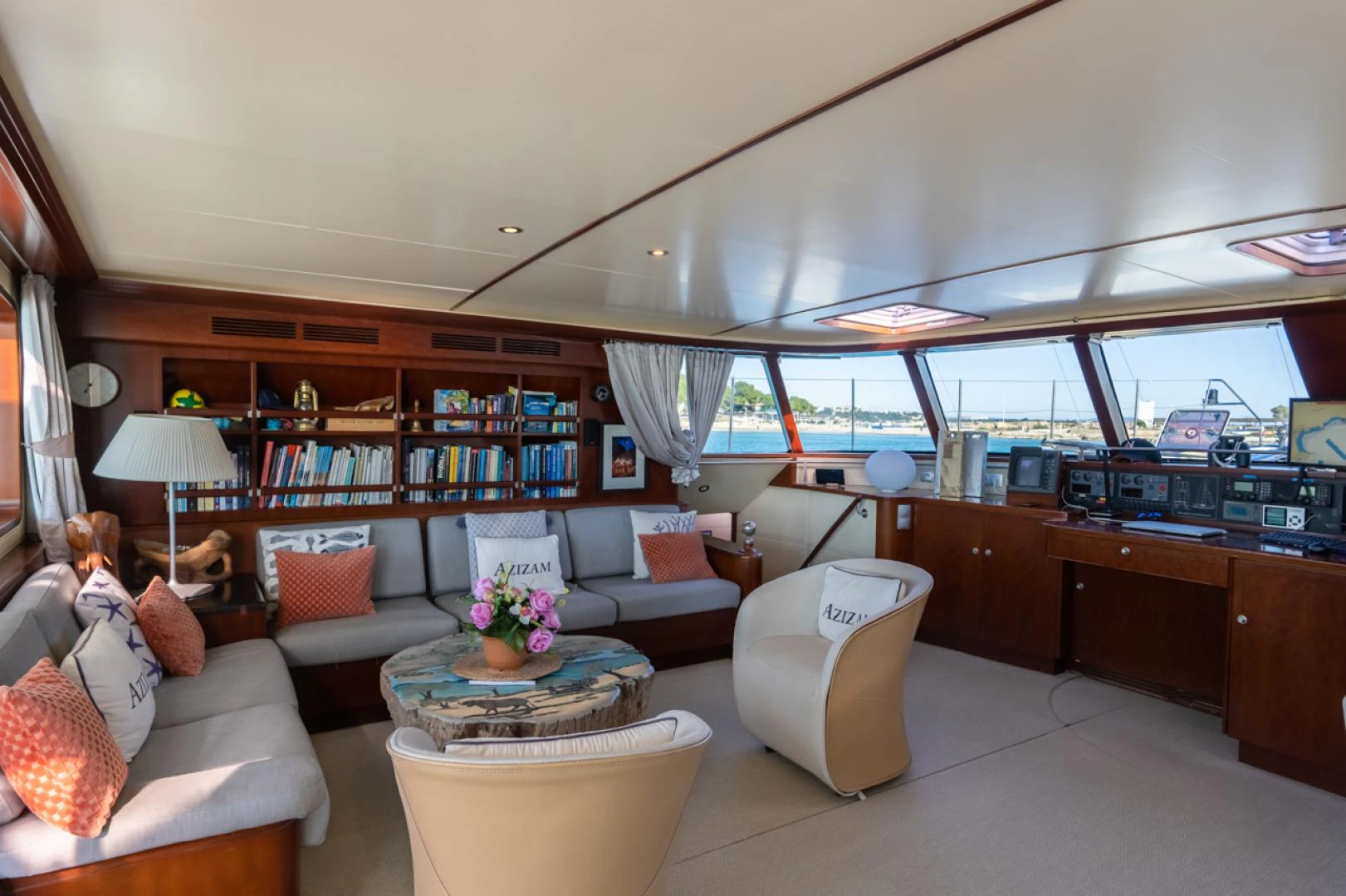 a living room with a large window aboard AZIZAM Yacht for Sale