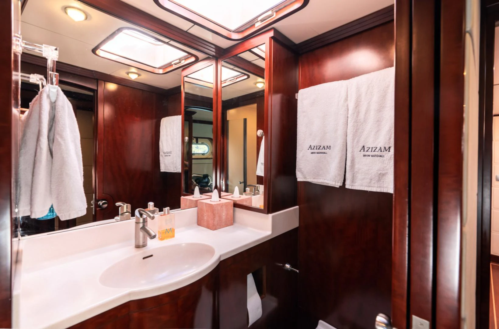 a bathroom with a large mirror aboard AZIZAM Yacht for Sale