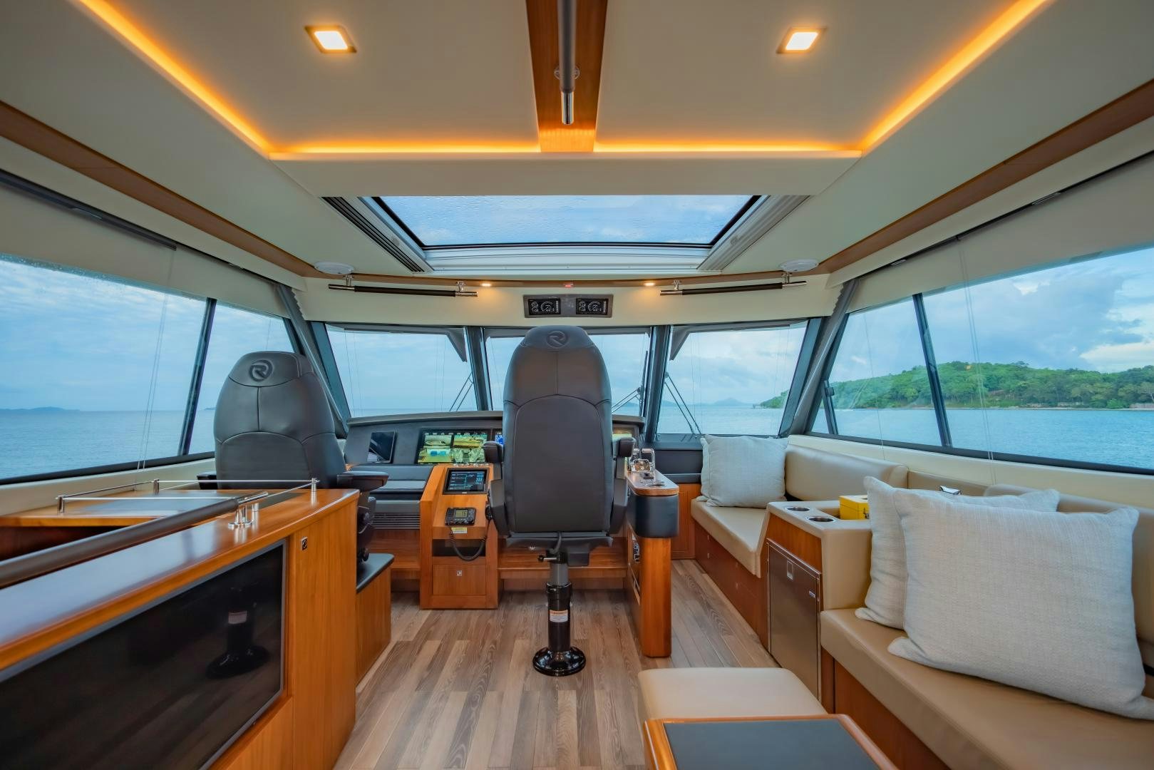 inside of a vehicle with a desk and chairs aboard FAT BOY Yacht for Sale