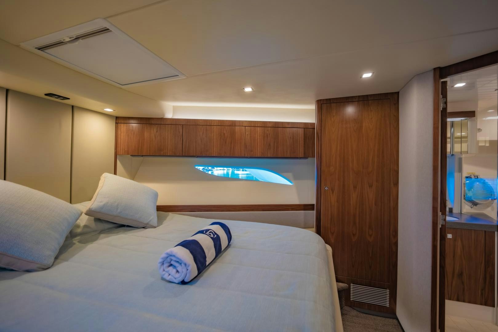 a bed with a blue pillow aboard FAT BOY Yacht for Sale