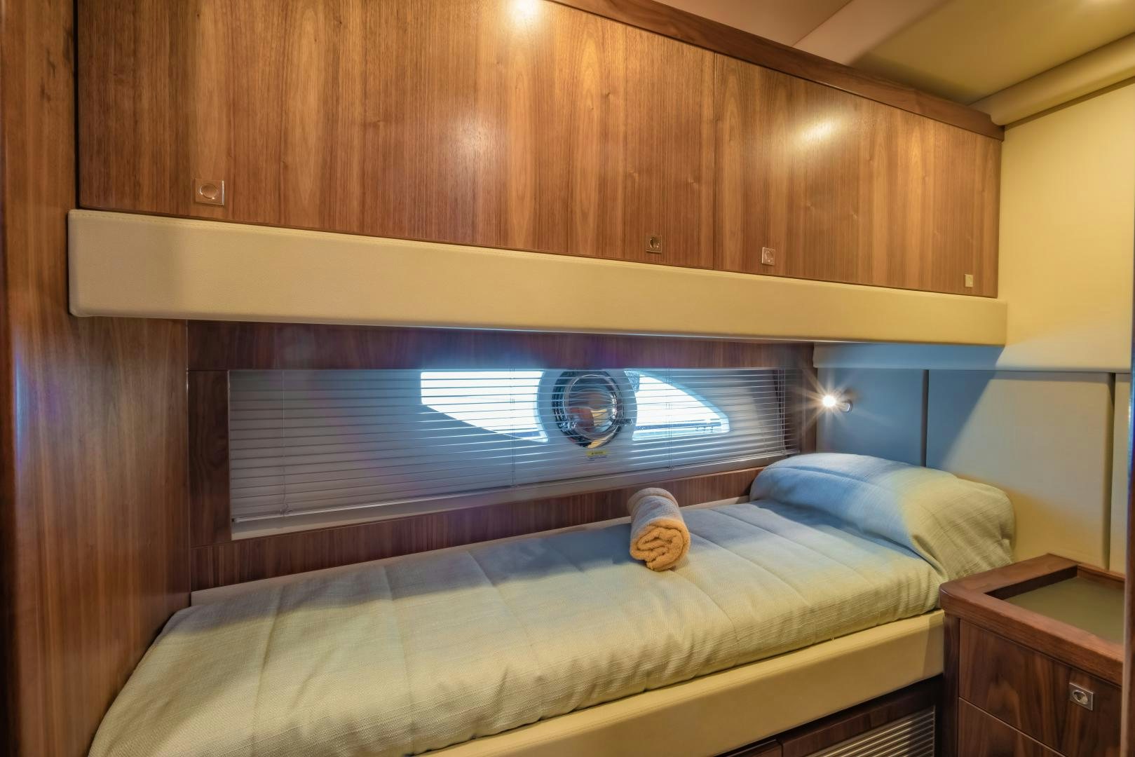 a bed with a window aboard FAT BOY Yacht for Sale