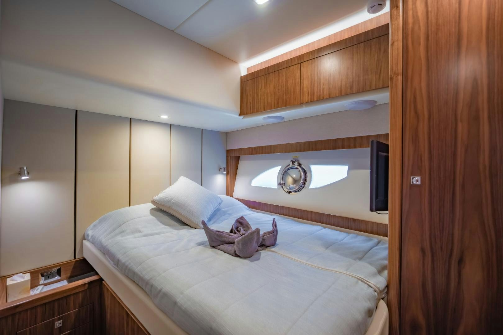 a room with a bed and a television aboard FAT BOY Yacht for Sale
