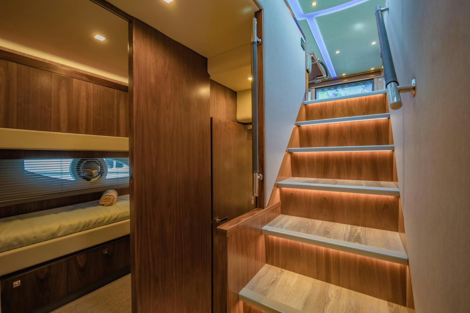a wooden staircase with a wood railing aboard FAT BOY Yacht for Sale
