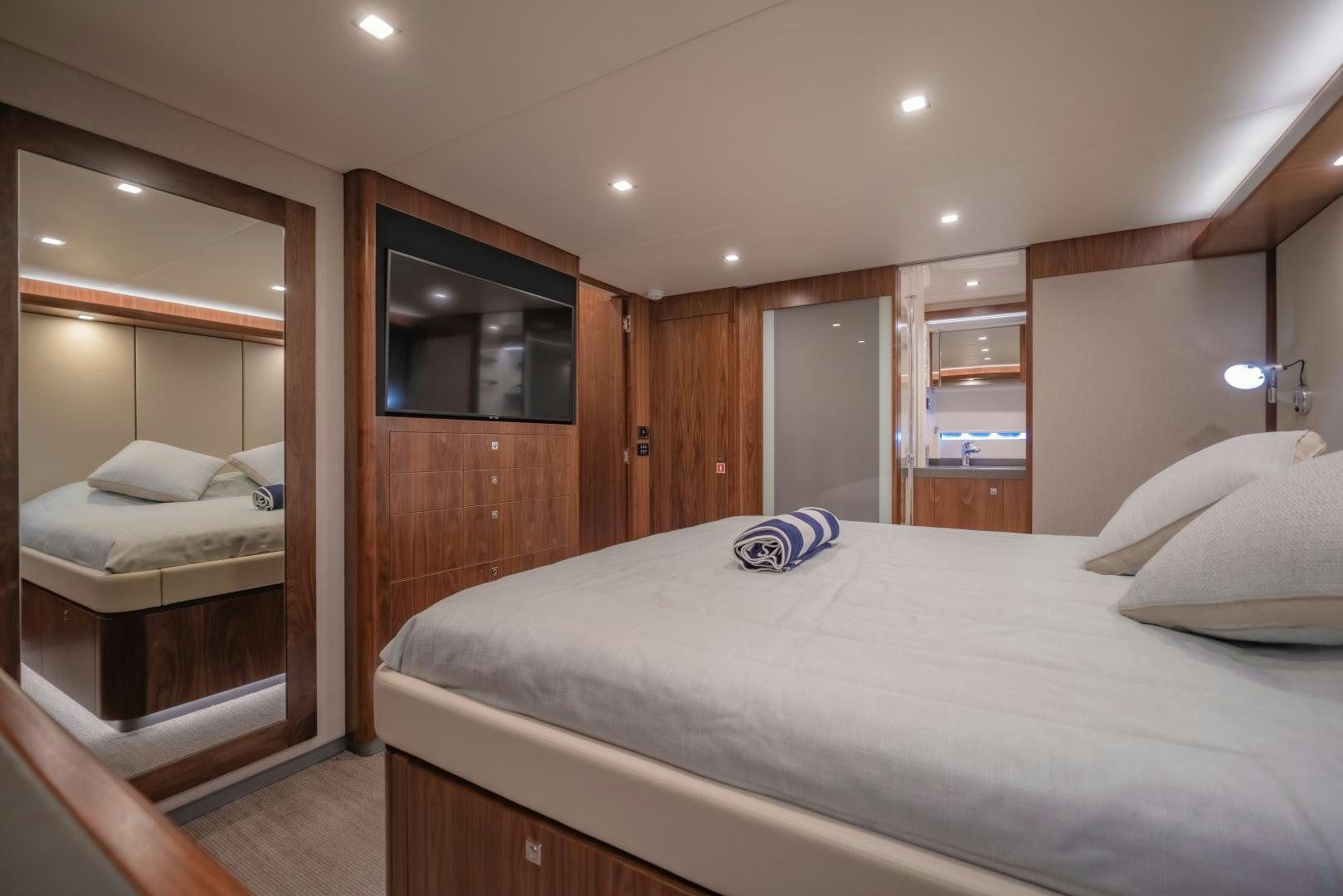 a bedroom with a bed and a television aboard FAT BOY Yacht for Sale