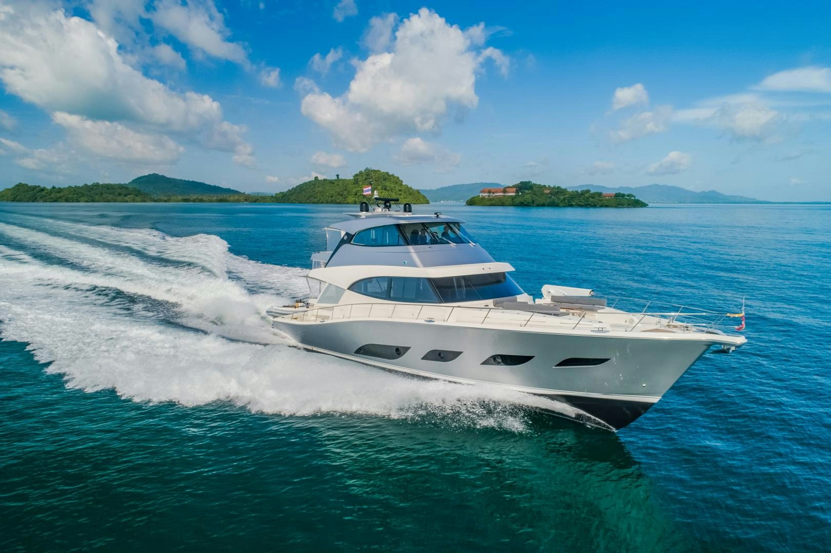 a white yacht on the water aboard FAT BOY Yacht for Sale