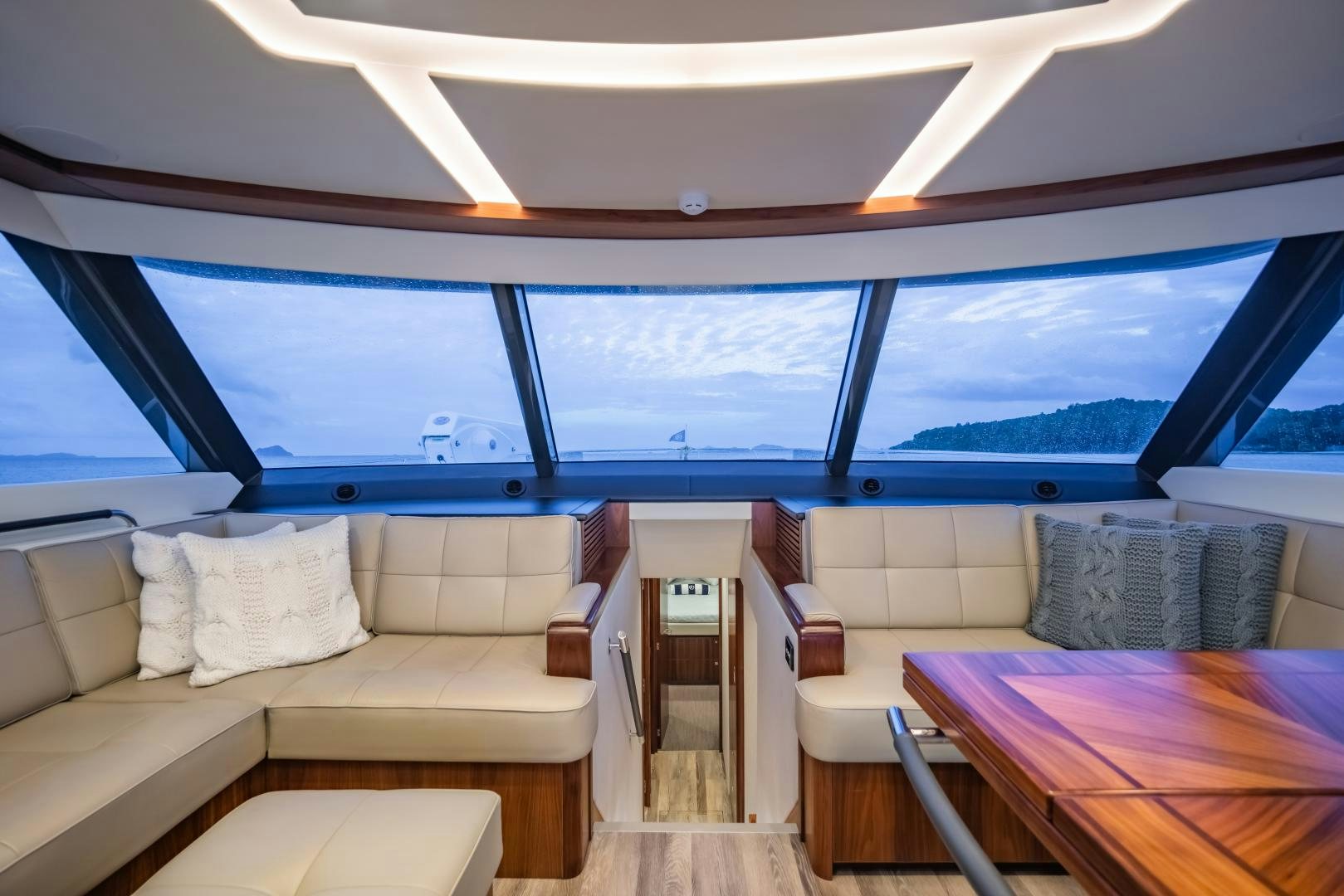 a room with a couch and a table and a view of the ocean aboard FAT BOY Yacht for Sale