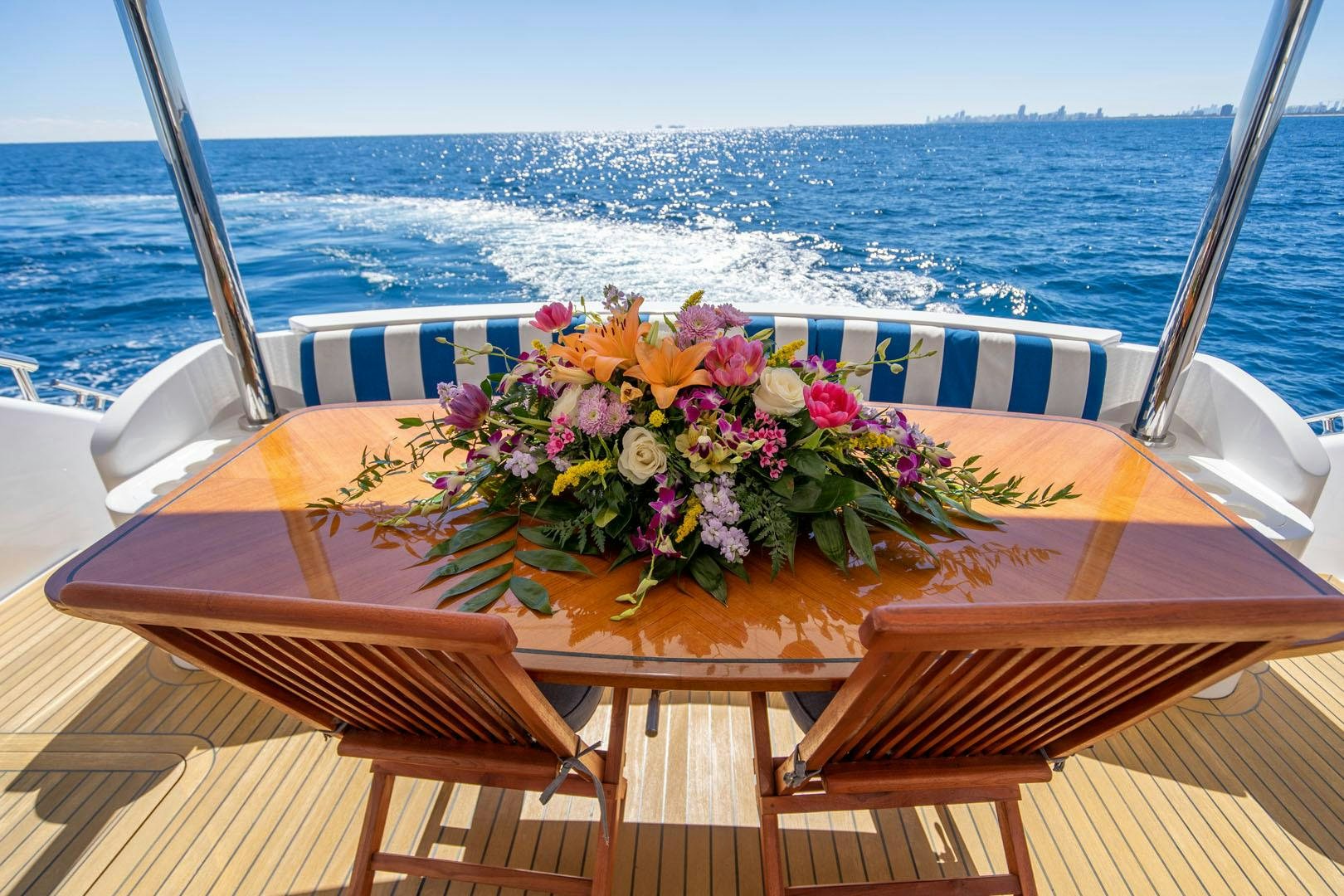 a table with flowers on it aboard LIFE Yacht for Sale