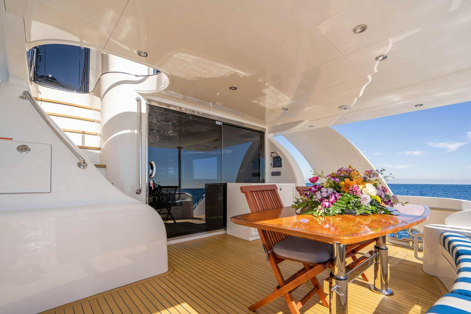 a room with a table and chairs aboard LIFE Yacht for Sale
