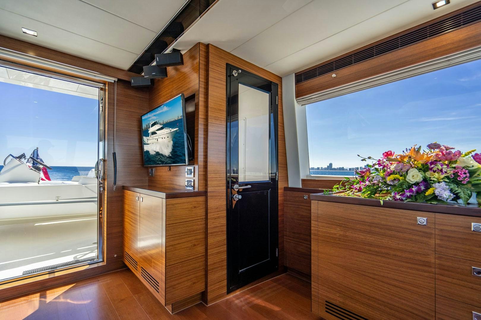 a room with a tv and a cabinet aboard LIFE Yacht for Sale