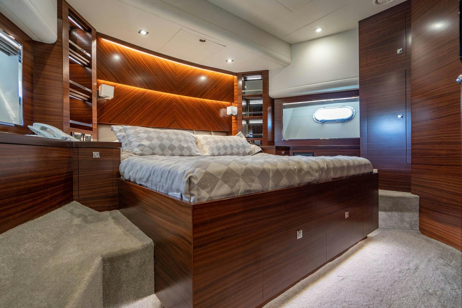 a bedroom with a bed and a wood wall aboard LIFE Yacht for Sale