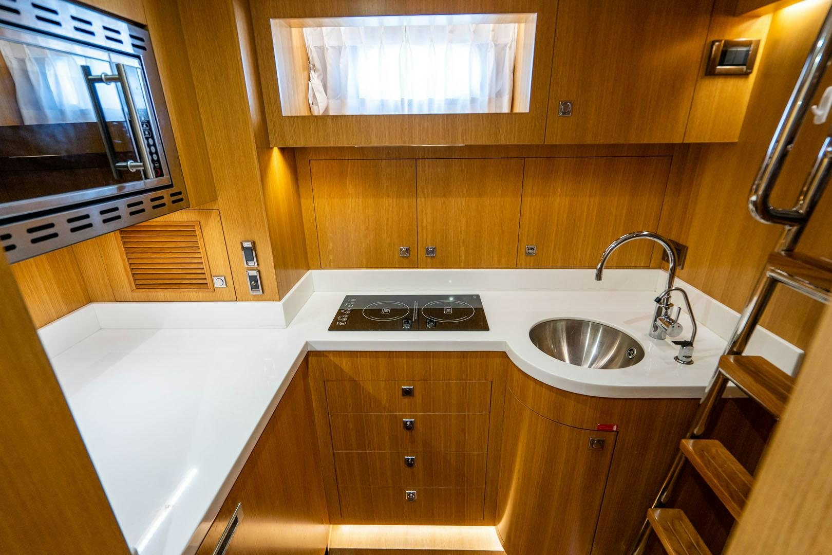 a kitchen with wooden cabinets aboard LIFE Yacht for Sale