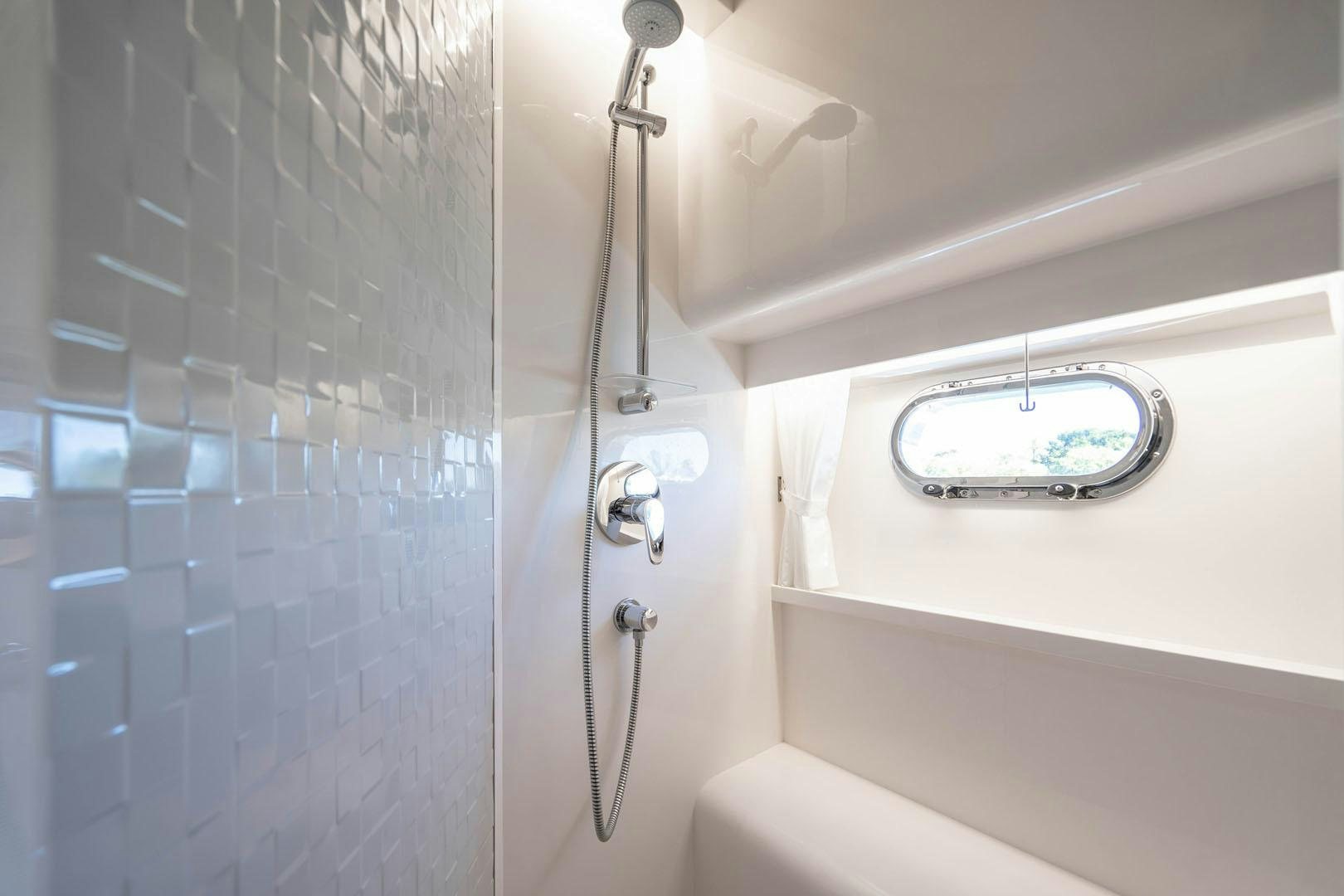 a shower with a sink and a mirror aboard LIFE Yacht for Sale