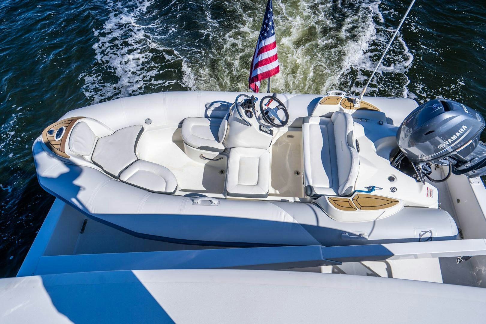 a boat with a flag on the front aboard LIFE Yacht for Sale