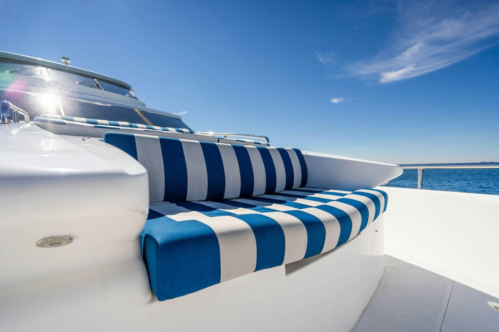a white boat with blue stripes aboard LIFE Yacht for Sale