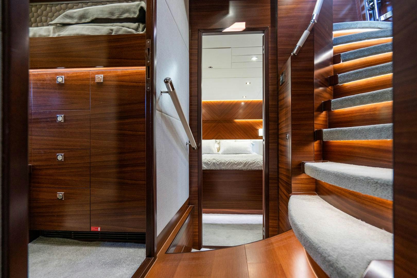 a room with a wood door and a bed aboard LIFE Yacht for Sale