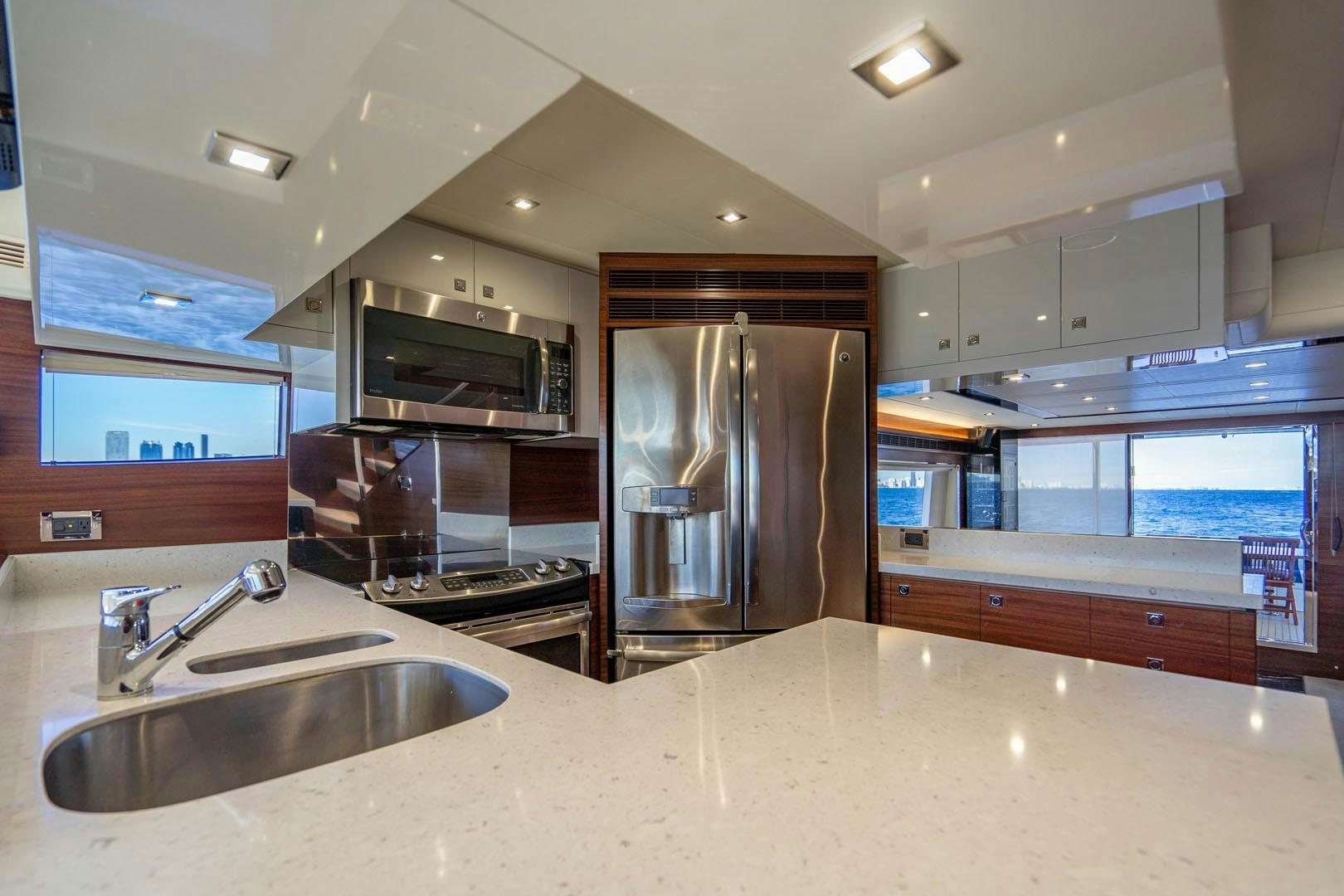 a kitchen with a stainless steel refrigerator aboard LIFE Yacht for Sale