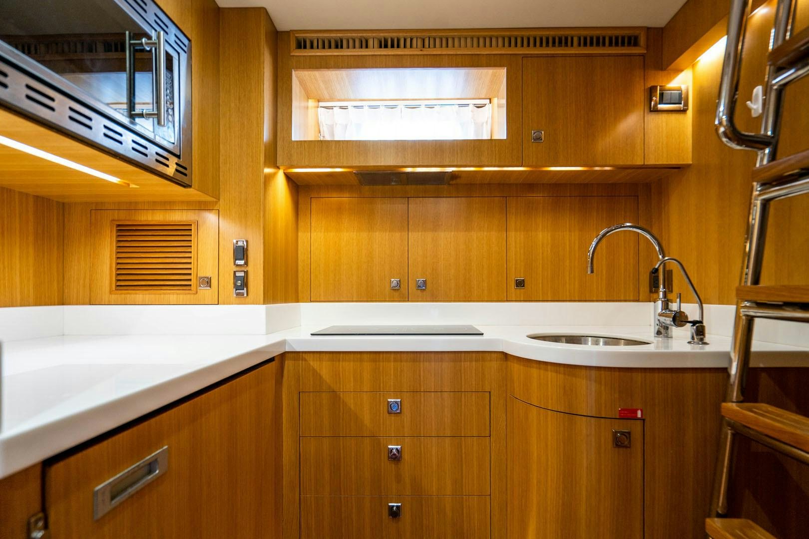 a kitchen with wooden cabinets aboard LIFE Yacht for Sale