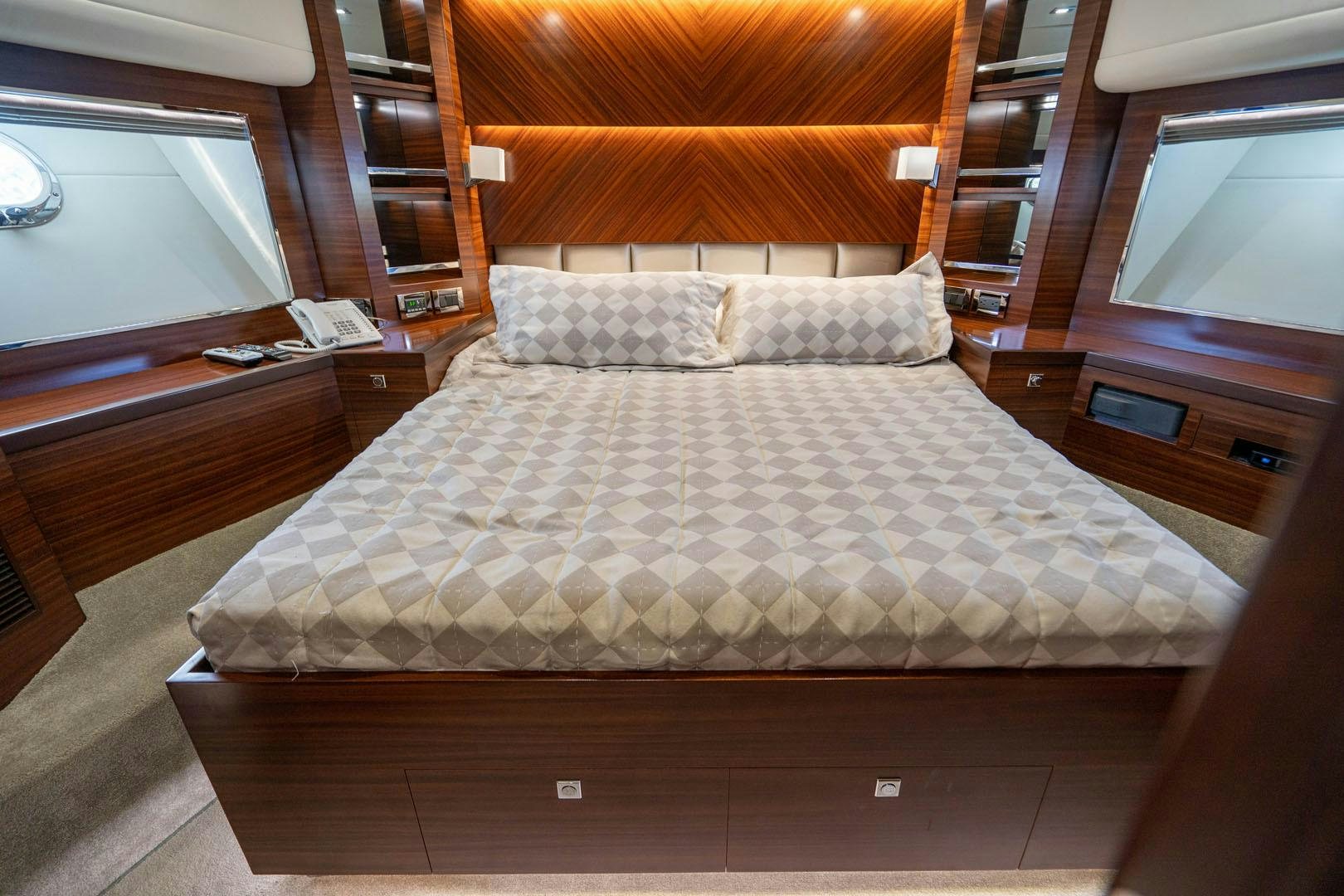 a bed with a white comforter aboard LIFE Yacht for Sale