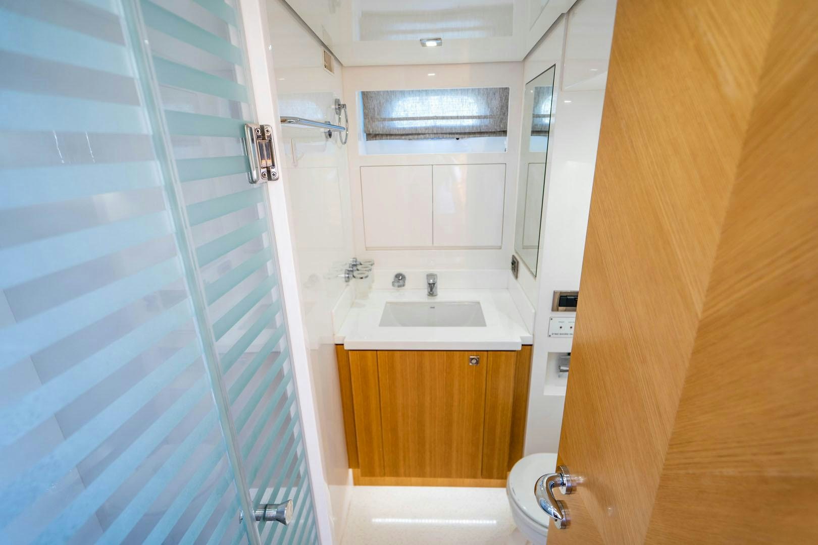 a bathroom with a shower unit and sink aboard LIFE Yacht for Sale