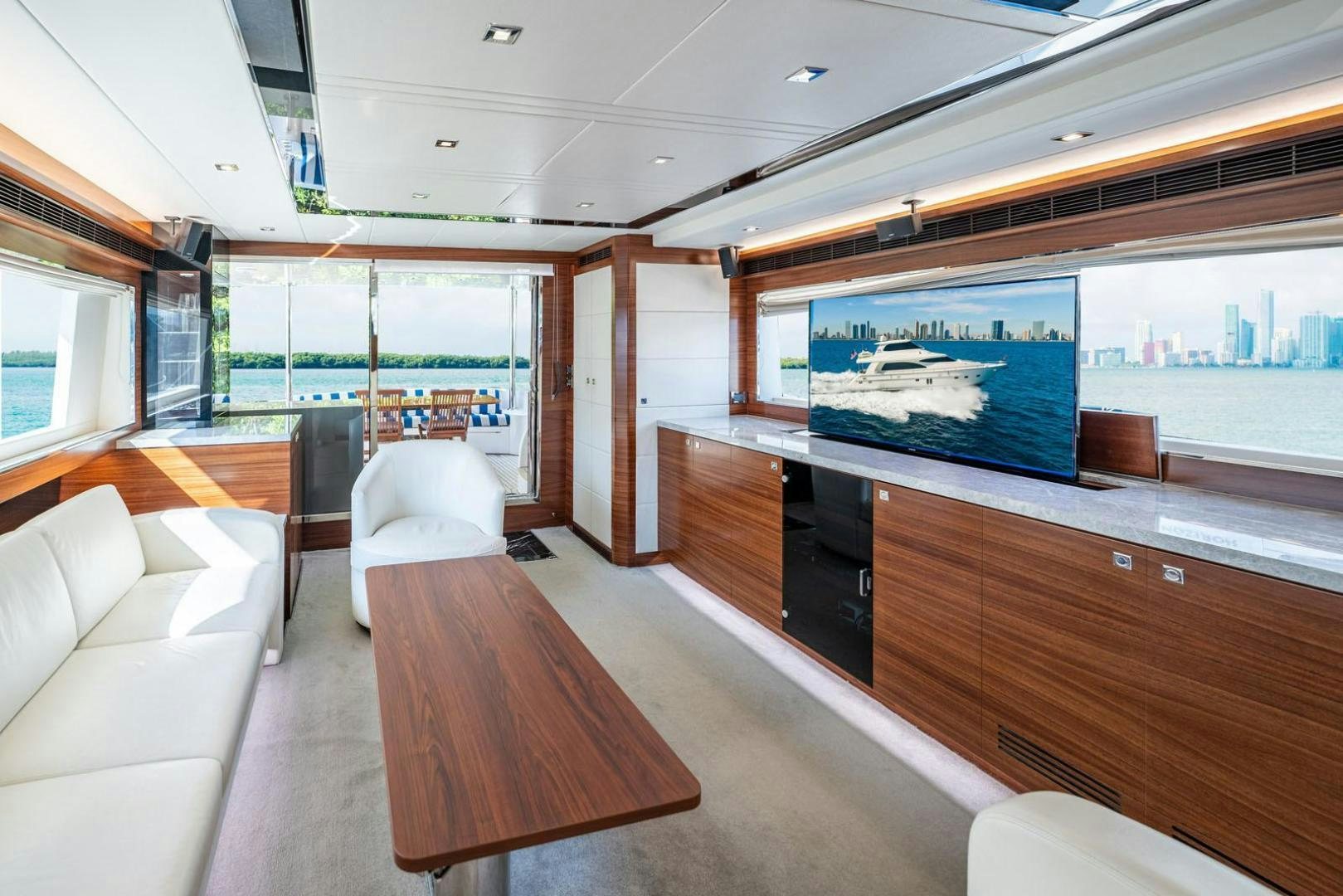 a room with a table and couches aboard LIFE Yacht for Sale