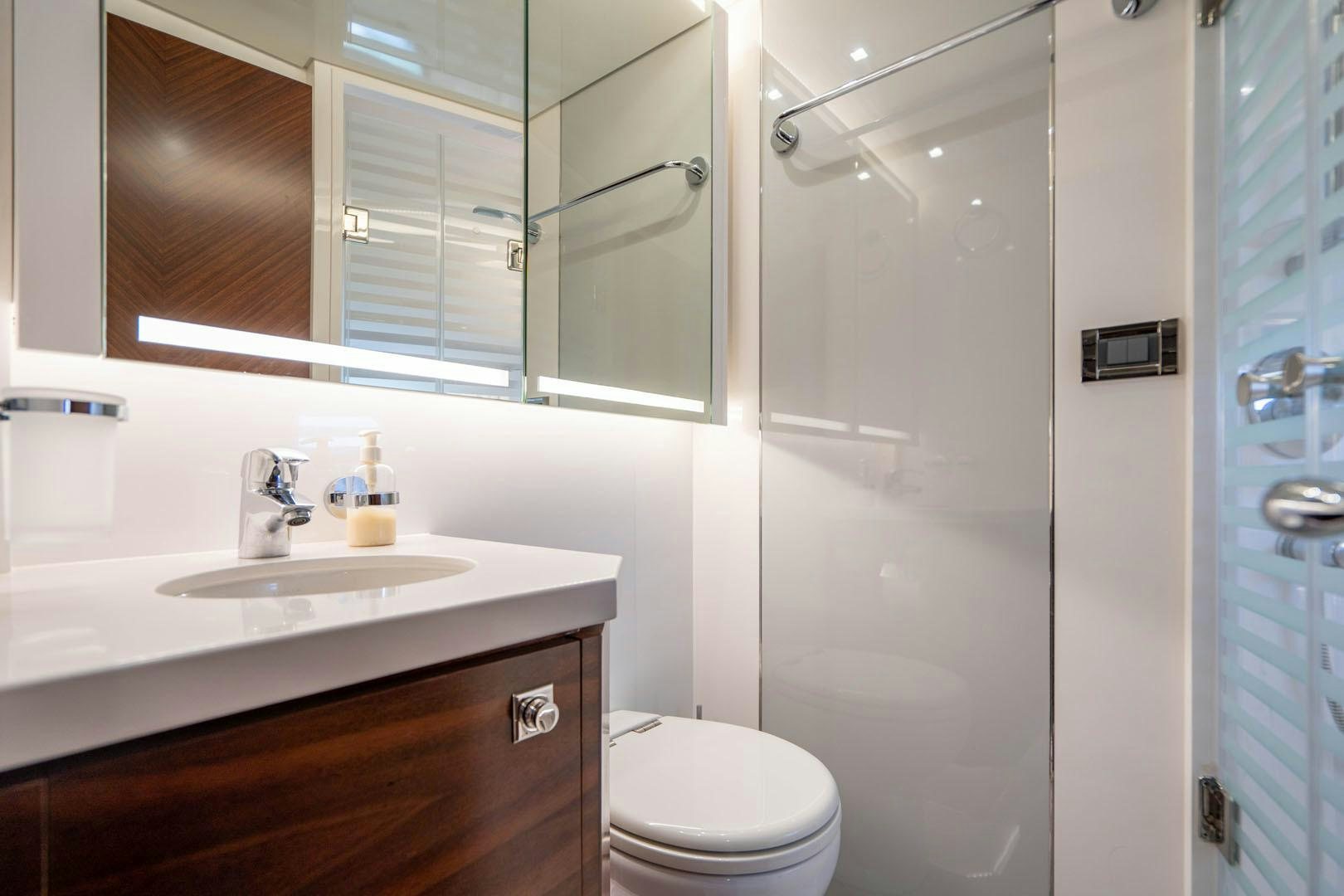 a bathroom with a glass shower door aboard LIFE Yacht for Sale