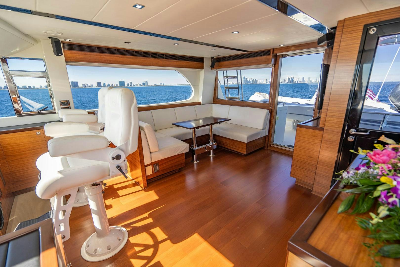 a room with a table chairs and a large window aboard LIFE Yacht for Sale