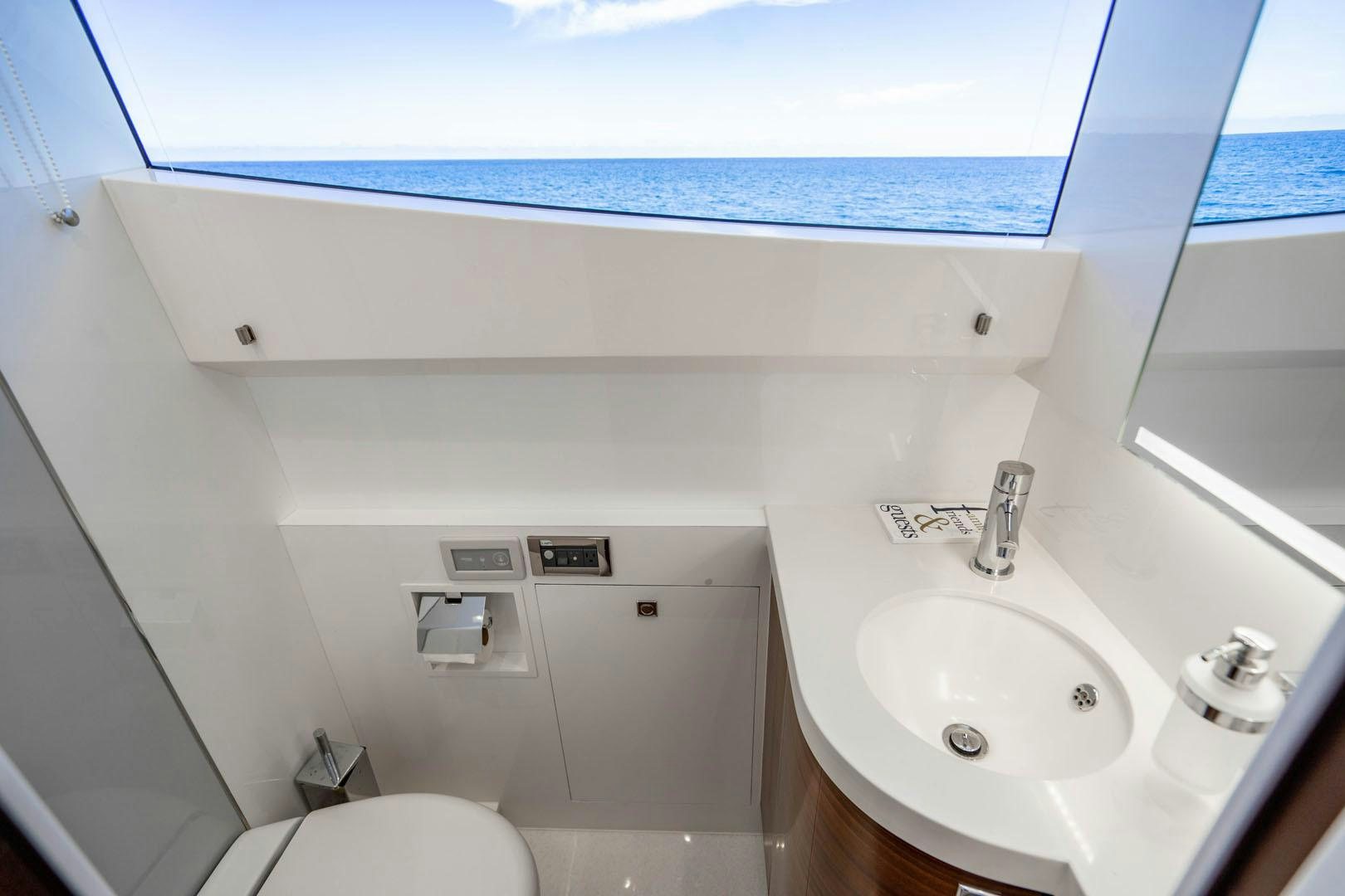 a bathroom with a sink and a window aboard LIFE Yacht for Sale