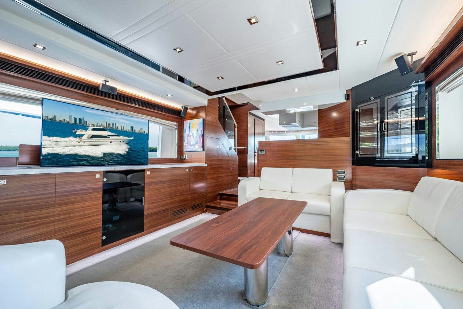 a living room with a tv and sofas aboard LIFE Yacht for Sale