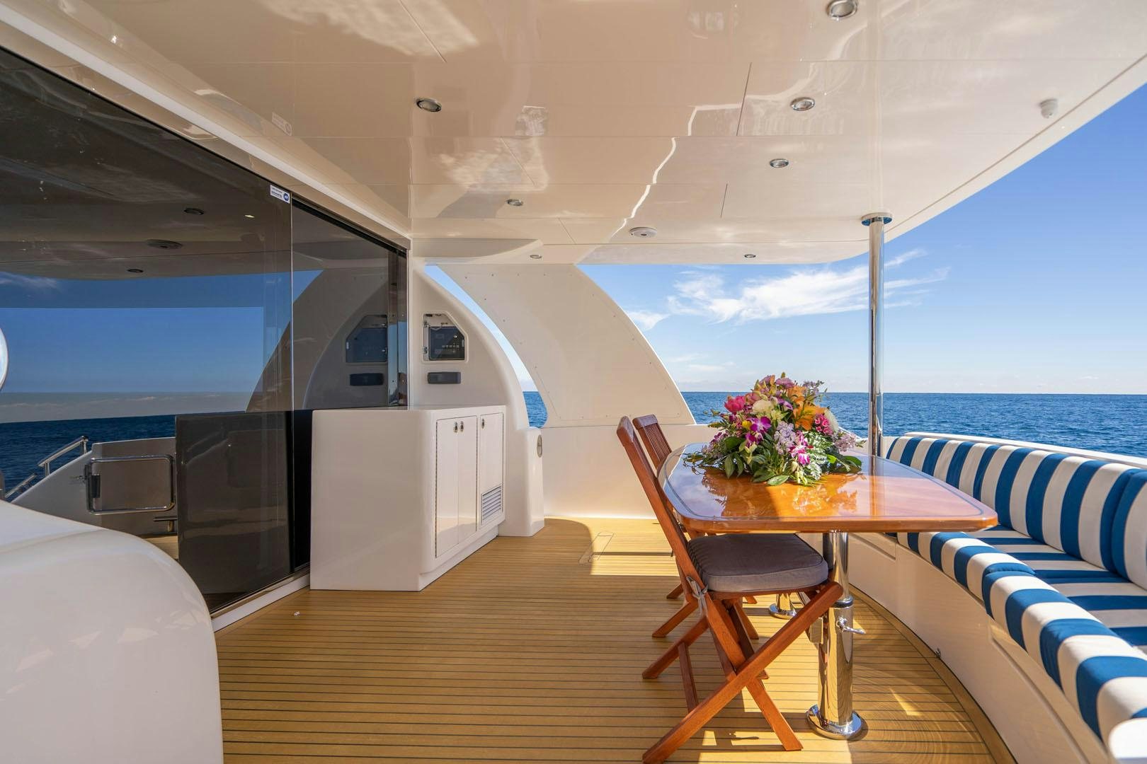 a boat with a table and chairs aboard LIFE Yacht for Sale