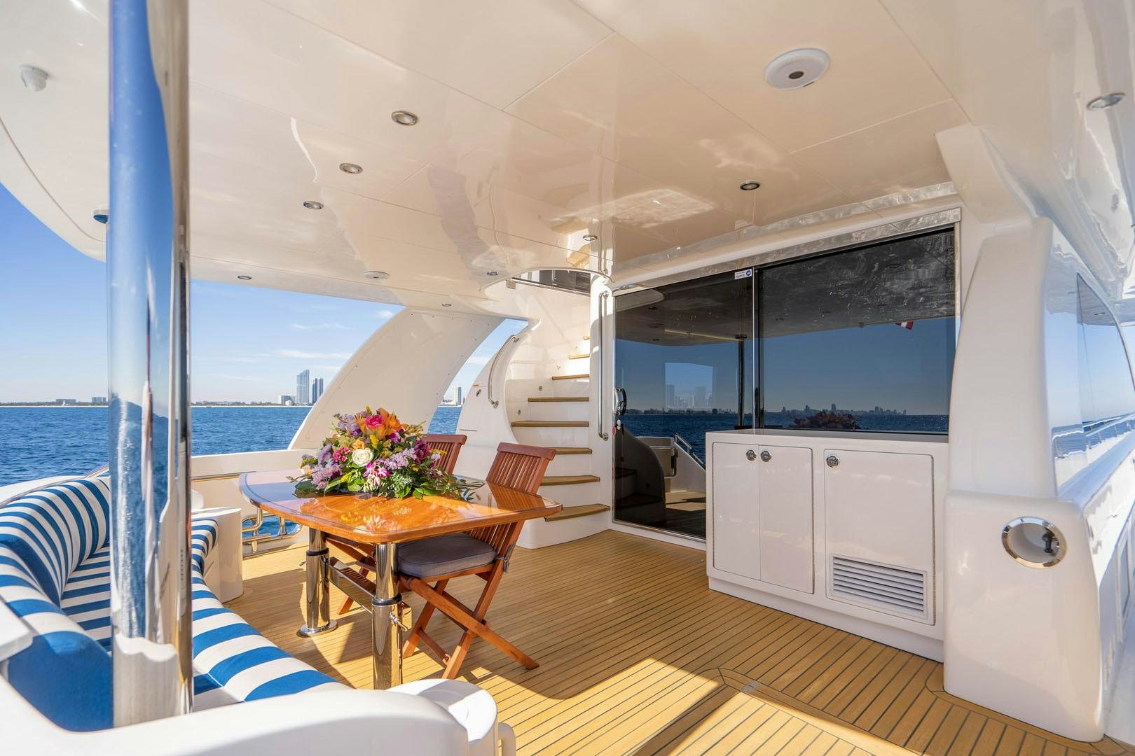 a room with a table and chairs aboard LIFE Yacht for Sale