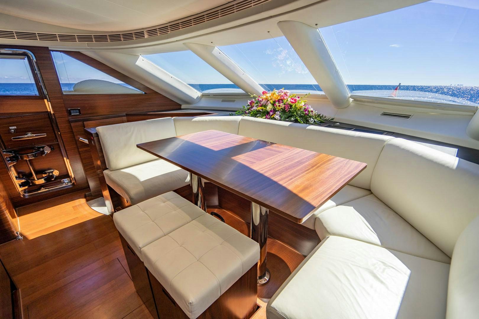 a room with a table and chairs aboard LIFE Yacht for Sale
