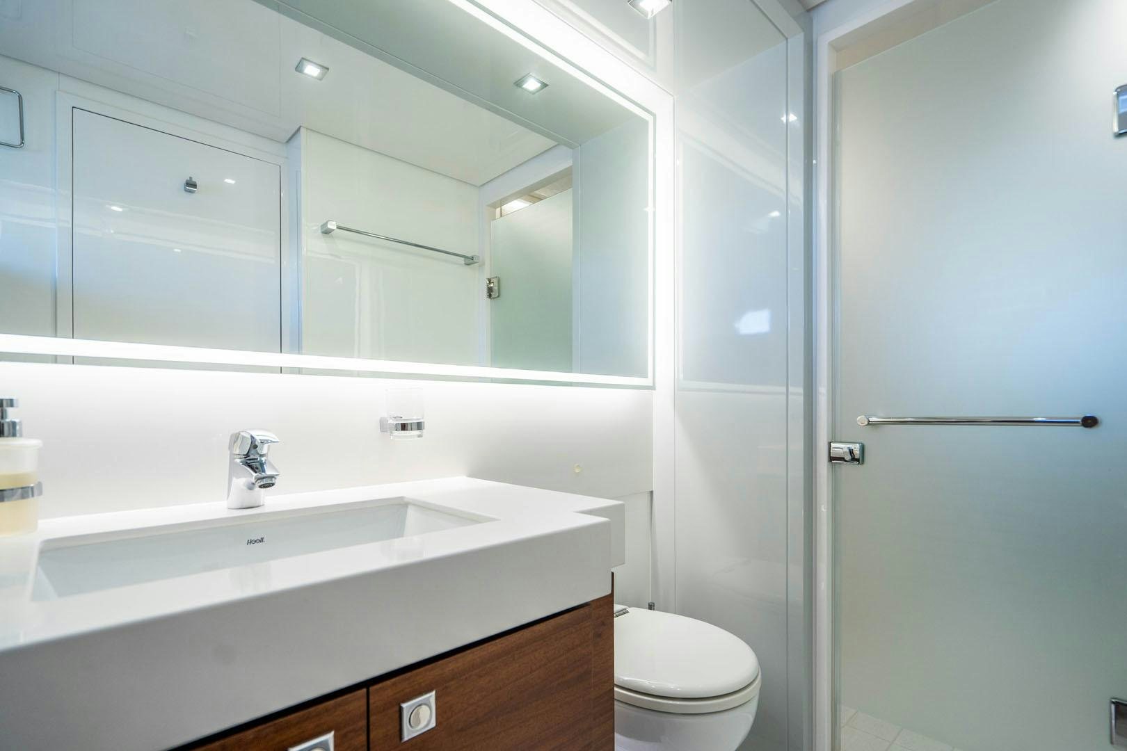a bathroom with a glass shower door aboard LIFE Yacht for Sale