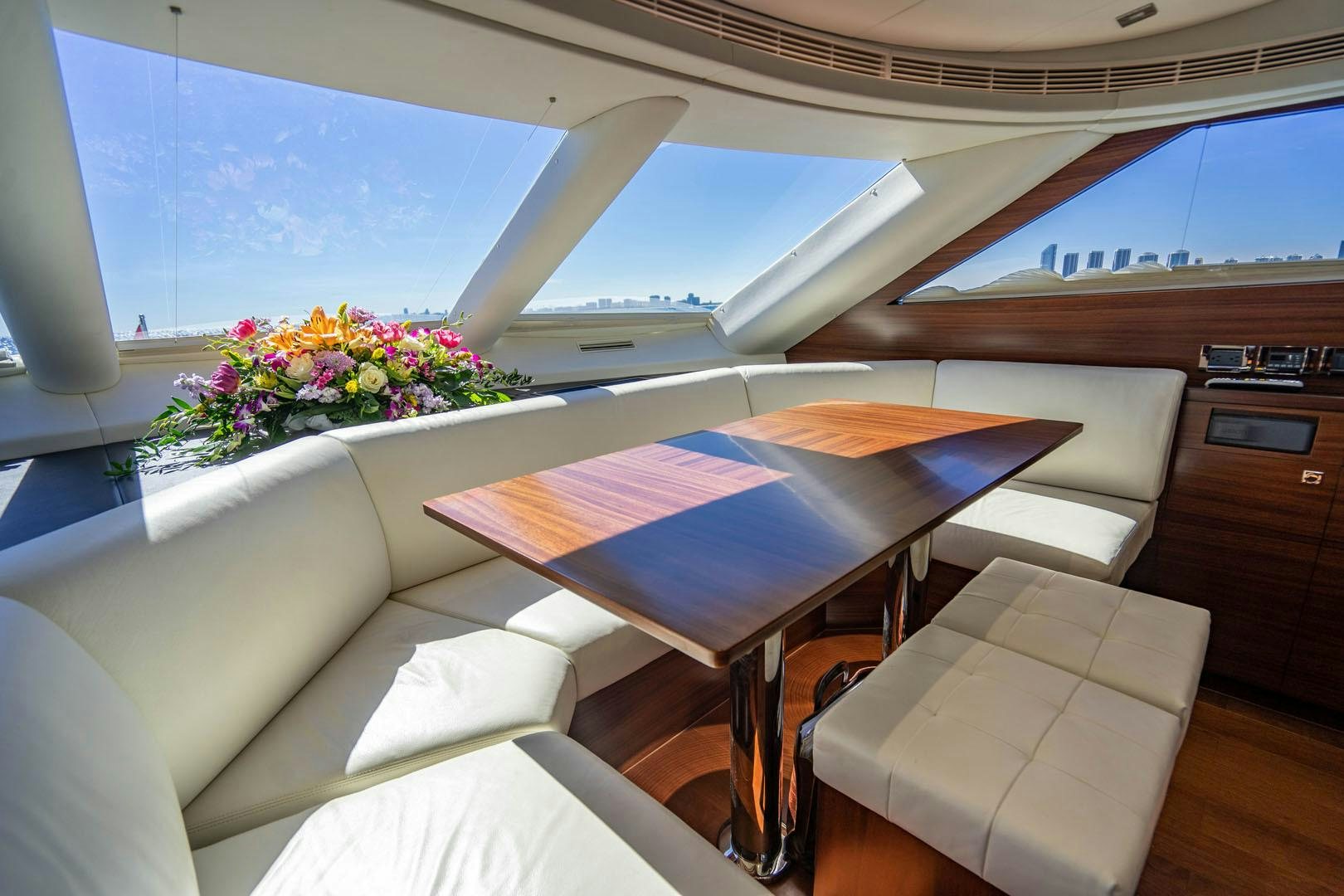a room with a table and chairs aboard LIFE Yacht for Sale