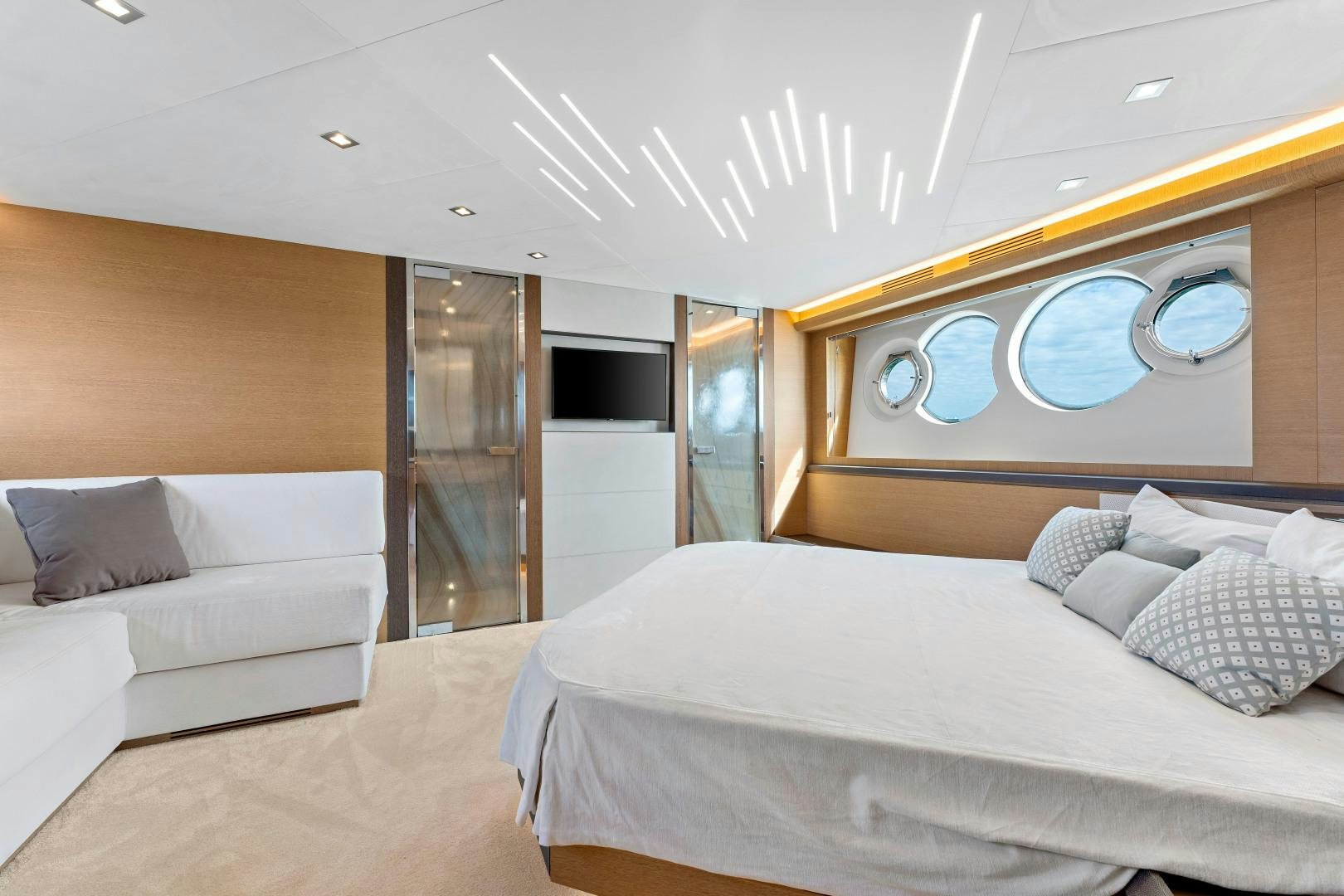 a room with a bed and a couch aboard MONTE CARLO Yacht for Sale