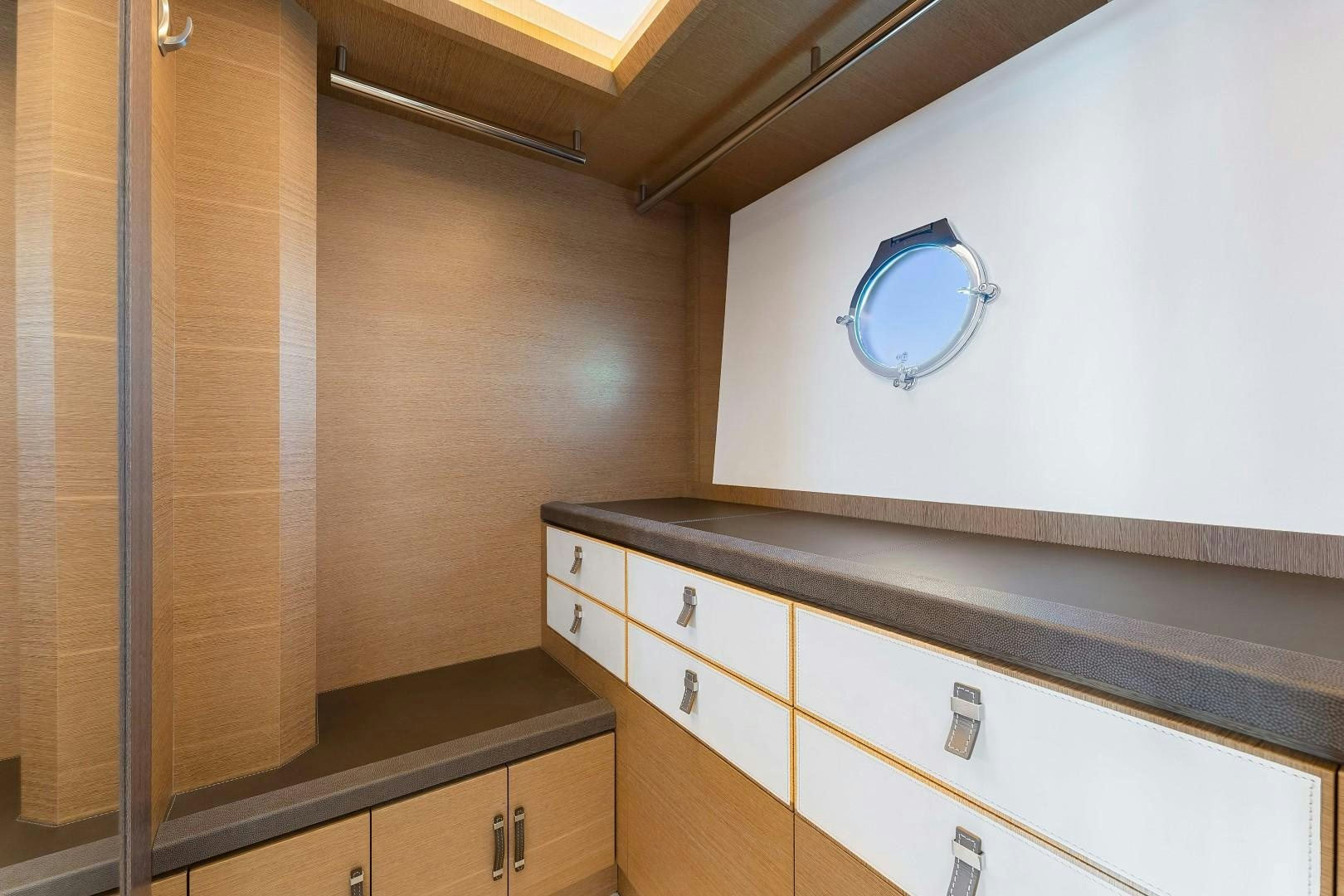 a room with cabinets and a mirror aboard MONTE CARLO Yacht for Sale
