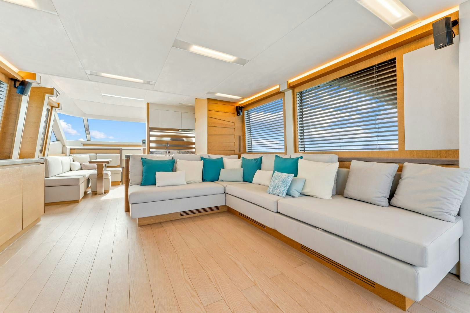 a living room with a couch and a large window aboard MONTE CARLO Yacht for Sale