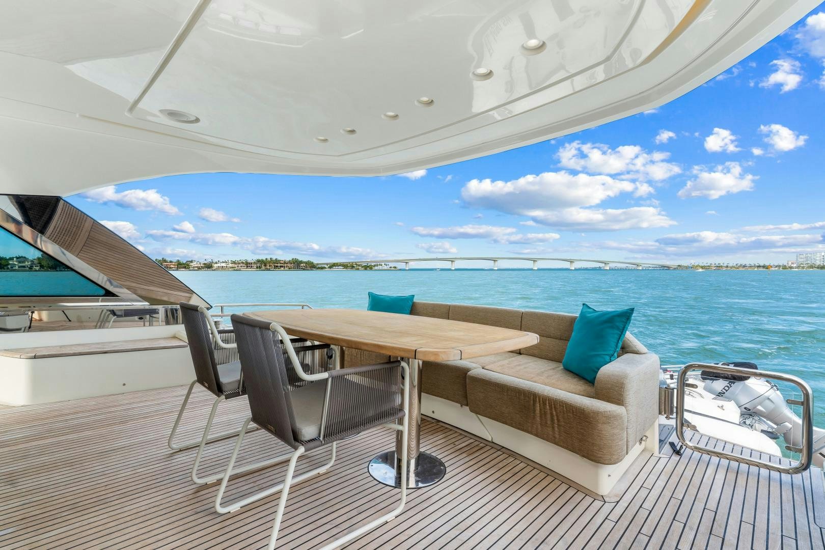 a table and chairs on a deck overlooking a large body of water aboard MONTE CARLO Yacht for Sale