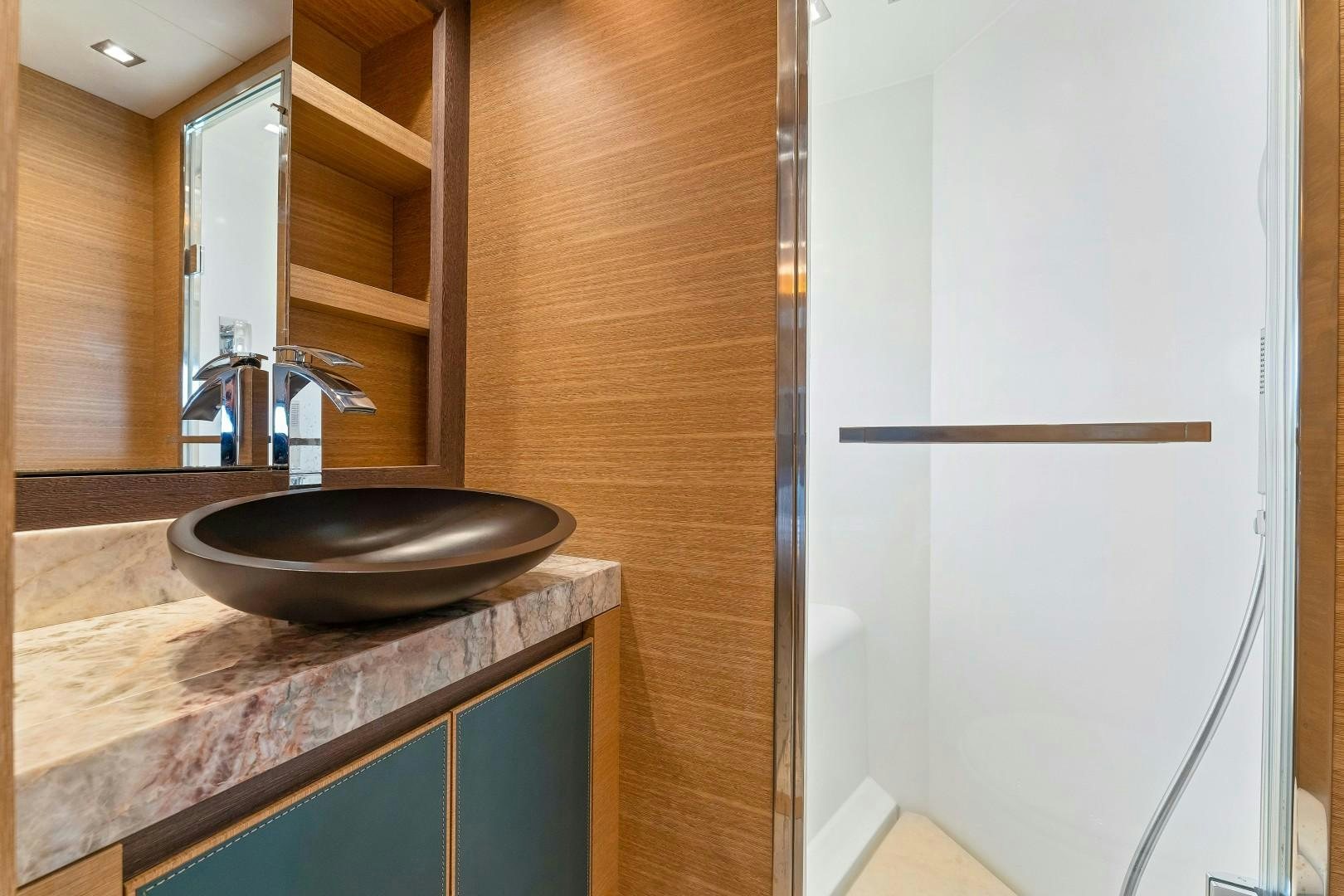 a bathroom with a sink and a mirror aboard MONTE CARLO Yacht for Sale