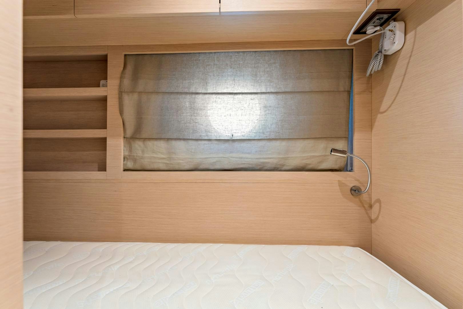 a bed with a wooden frame aboard MONTE CARLO Yacht for Sale