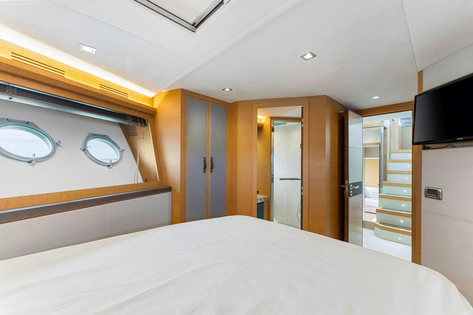 a room with a bed and a television aboard MONTE CARLO Yacht for Sale