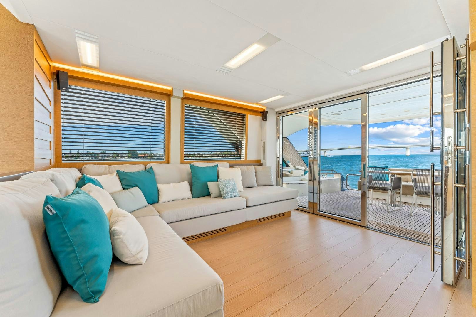 a living room with a large glass door aboard MONTE CARLO Yacht for Sale