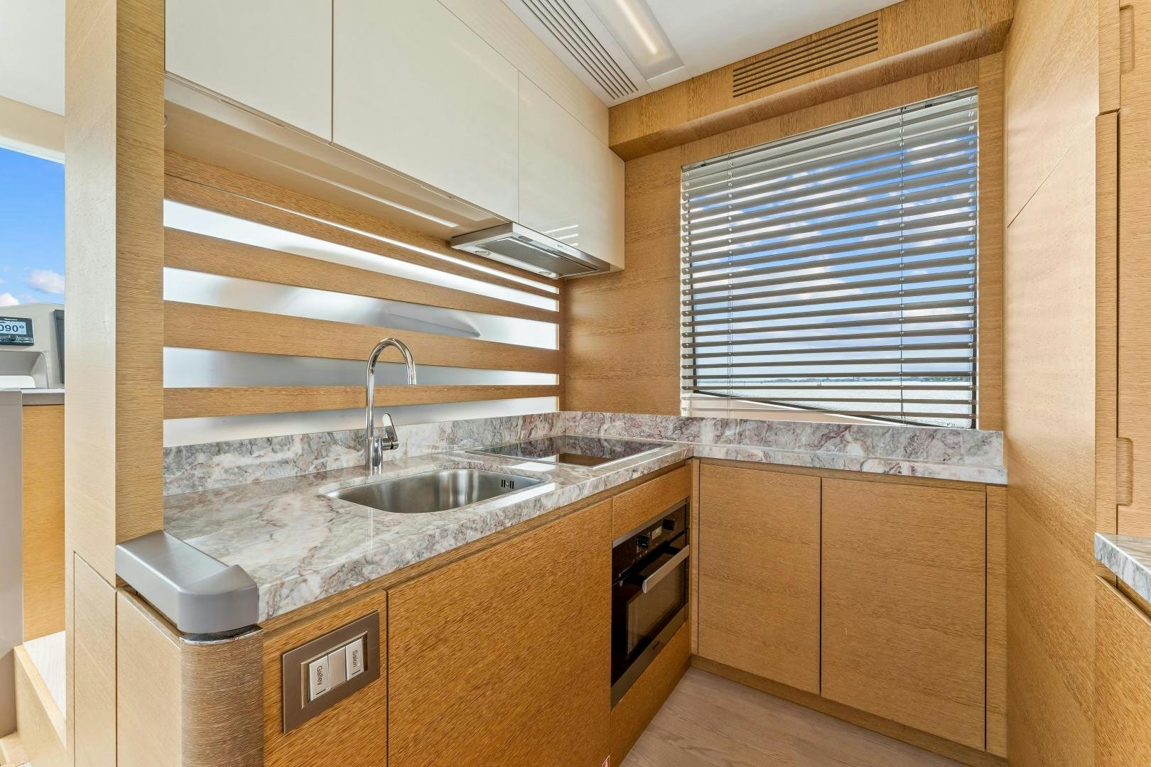 a kitchen with wooden cabinets aboard MONTE CARLO Yacht for Sale