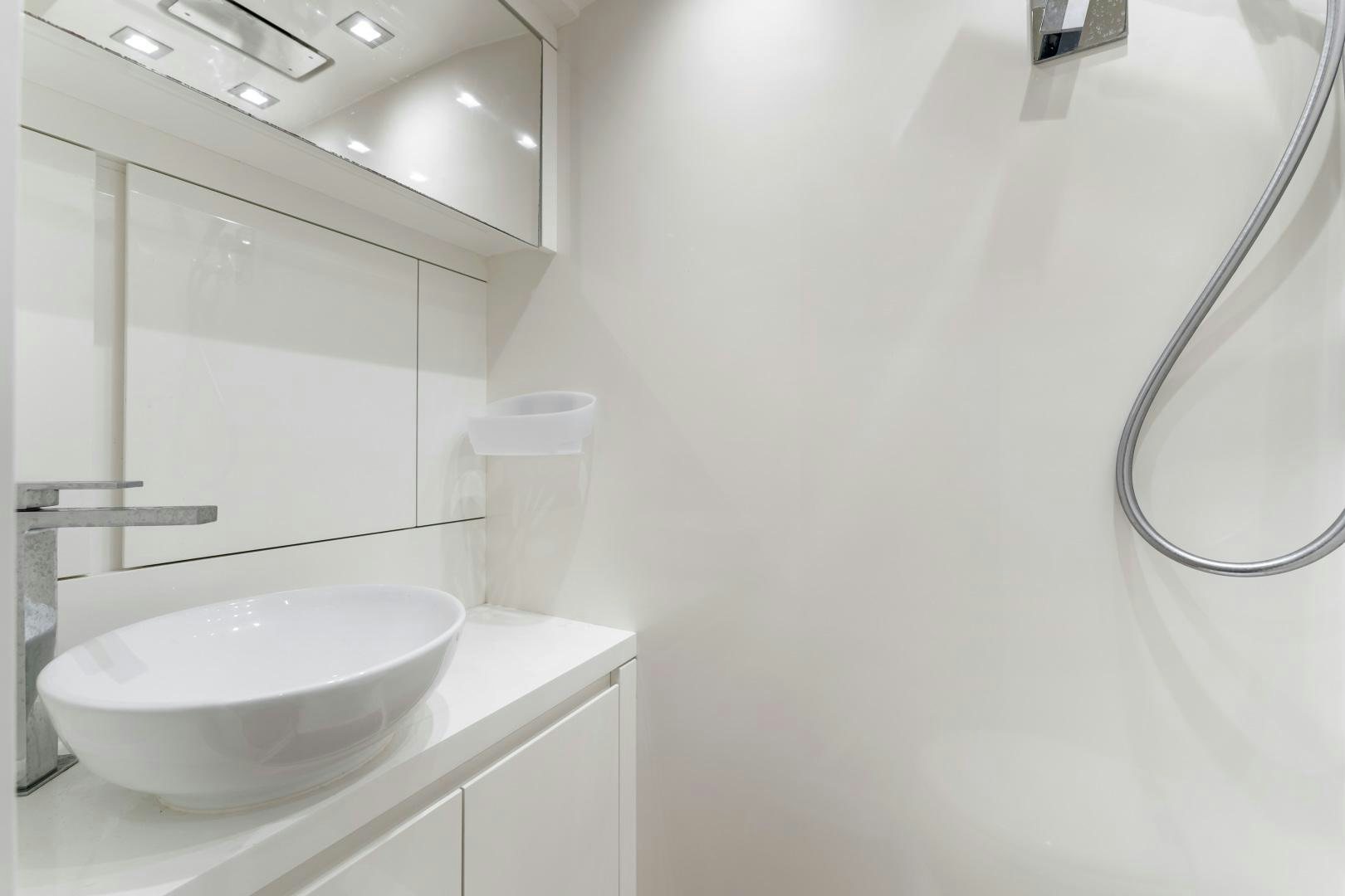 a bathroom with a sink and a shower aboard MONTE CARLO Yacht for Sale